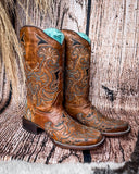 Side view of the Saddleback Shadow Corral Boots in a wood backdrop.