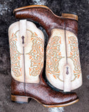 The Canyon Lace Corral Boots displayed on cowhide.