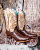 Side view of the Canyon Lace Corral Boots in a wood backdrop.