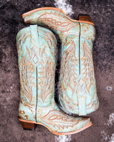 The High Noon Belle Corral Boots displayed on cowhide.