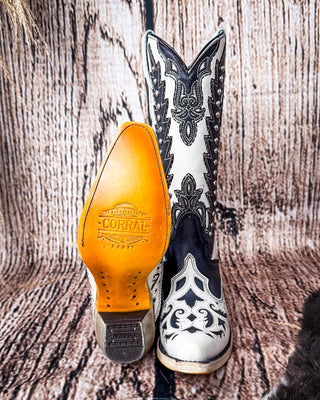 Front and bottom of the Phantom Mesa Corral Boots in a wood backdrop.