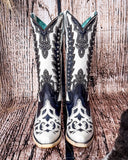 Front view of the Phantom Mesa Corral Boots in a wood backdrop.
