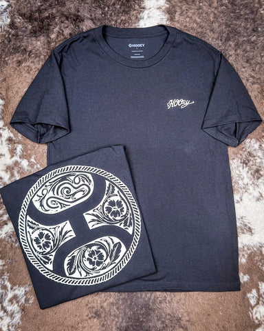 The Concho Hooey T-Shirt displayed on cowhide, showing design on the back.