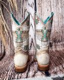 Back view of the Feathered Frontier Corral Boots with a wood backdrop.