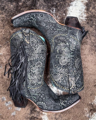 The Dahlia Dust Corral Boots displayed on cowhide.