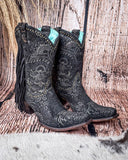 Side view of the Dahlia Dust Corral Boots with a wood backdrop.