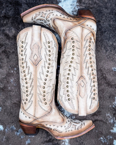 The Phantom Dune Corral Boots displayed on cowhide.