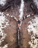 The Peppered Hair On Hide Breast Collar displayed on cowhide.