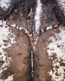 The Peppered Hair On Hide Breast Collar and Single ear Headstall displayed on cowhide.