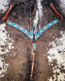 The Turquoise Wash Bull Coin Breast Collar and Headstall displayed on cowhide.