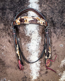 Zoom in of the Peppered Hair On Hide Browband Headstall displayed on cowhide showing design.