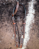Turquoise Rawhide One Ear Headstall displayed on cowhide.