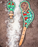 Painted Cactus Ladies Spur Straps displayed on cowhide.