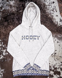 Front view of the Trophy Ladies Hooey Hoodie in Oatmeal on cowhide.