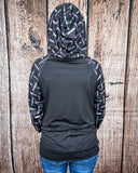 Hood up back view of the Cinched Up T-Shirt Hoodie on a model in front of a wood backdrop.
