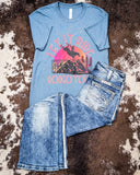 Let it Ride Rodeo Tour Graphic Tee displayed and styled on hide.