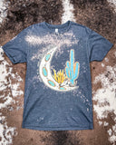 Desert Child Graphic Tee displayed on hide background.