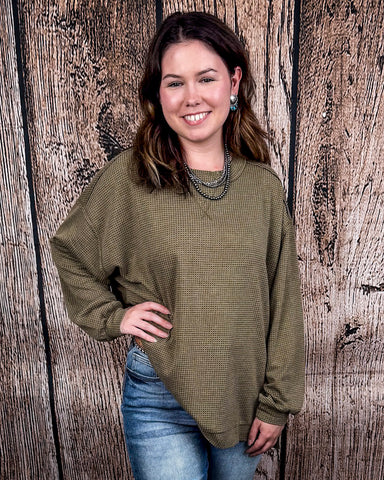 The Stillwater Tunic Top in Olive being styled and modeled on women in front of wooden backdrop.