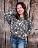 Tooled in Love Ribbed Sweater Top being modeled and styled on a women in front of wood backdrop.