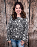 Tooled in Love Ribbed Sweater Top being modeled and styled on a women in front of wood backdrop.