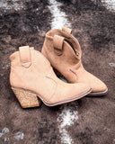 Dangerous Ankle Bootie in Light Tan displayed on cowhide background.