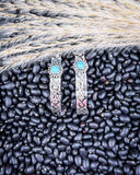 Thunderbird Hoop Fashion Earrings displayed on black pebbles and wheat background.