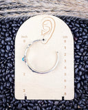 Thunderbird Hoop Fashion Earrings displayed measurements in front of black pebbles background.