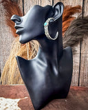 Thunderbird Hoop Fashion Earrings displayed mannequin in front of wood and wheat background.