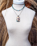 Wild West Layered Fashion Necklace displayed on mannequin in front of wheat background.