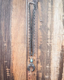 Jericho Layered Squash Blossom Fashion Necklace with faux turquoise displayed on wood with ruler.