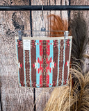 Ojo Caliente Towels displayed on a rod in front of wood background.