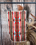 Ojo Caliente Towels displayed on a rod in front of wood background.