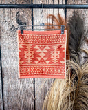 Navajo Adobe Towels displayed on rod in front of wood background.