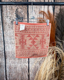Navajo Adobe Towels displayed on rod in front of wood background.