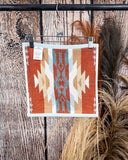 Pecos Towels displayed on rode in front of wood and wheat backdrop.
