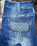Close up of Turquoise Boot Stitch Bootcut Jeans displayed on cowhide.