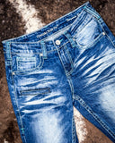 Close up of Turquoise Boot Stitch Bootcut Jeans displayed on cowhide.