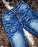 Blue jeans with brand logo on a textured brown surface