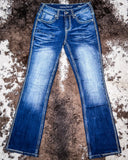 Pair of blue jeans on a textured brown surface