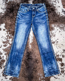Blue jeans on a textured brown surface