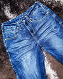 Blue jeans on a textured brown surface