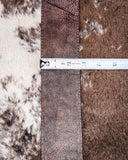 Leather purse strap with a ruler for scale on a fur background