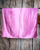 Wild rag laying over a metal bar