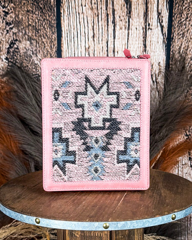 Pink jewelry box with geometric pattern on a wooden surface