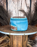 Blue leather pouch with decorative patterns on a wooden surface
