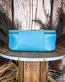 Blue pouch on a wooden stool with a rustic background