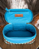 Blue cosmetic bag with 'MYRA BAG' logo on a wooden surface