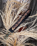 Decorative black key fob on a natural background