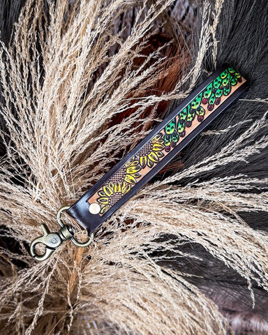 Leather key fob with decorative pattern on a textured surface