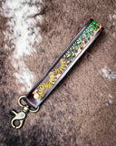 Leather keychain with floral design on a textured background